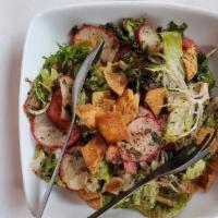 Fattoush · Veg. Mixed greens, tomatoes, cucumbers, bell pepper, fresh mint and parsley, topped with fri...