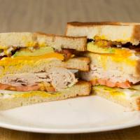 Turkey Club · Turkey, Cheddar, Avocado, Bacon, Lettuce, Tomatoes, Onion with Mayonnaise and Mustard.