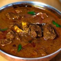 Goat Curry · Goat (Bone-in) slowly cooked to perfection in garlic, onion, ginger and spices.
