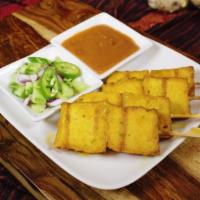 Tofu Sate · Vegetarian. Skewers of firm tofu marinated in Thai spices. Served with peanut sauce and swee...