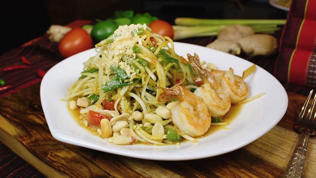 Blue Elephant Green Papaya Salad · Fine shredded green papaya tossed with green beans, tomatoes, peanuts, garlic, and hot chili. Served with grilled shrimp.