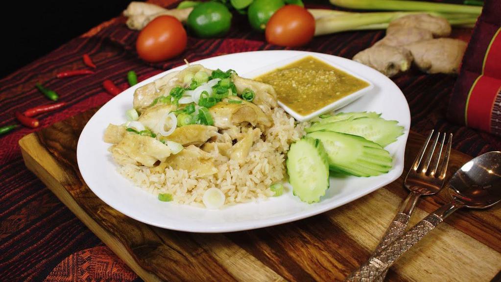 Hainan Chicken Rice · Chicken thigh, ginger rice, cucumber served with chicken broth and ginger spicy sauce or sweet and sour sauce.