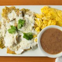 Chilaquiles · Crispy fried tortillas sauteed with onion. Topped with crema and cotija cheese. Accompanied ...