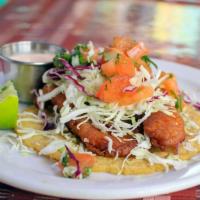 Baja Fish Taco · Topped with cabbage and pico de gallo and served on a fresh pressed corn tortilla with a sid...