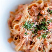 Bolognese** · House specialty. Traditional meat sauce, tagliatelle noodle, and grana padano cheese.