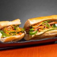 Chicken Banh Mi · Freshly baked baguette with a fried egg, house spread, cucumber, jalapeno, pickled carrot, c...