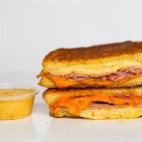 Smoked Ham & Three Cheese Melt · Smoked ham, Cheddar, Swiss, and Parmesan cheeses melted between buttery, toasted sourdough b...