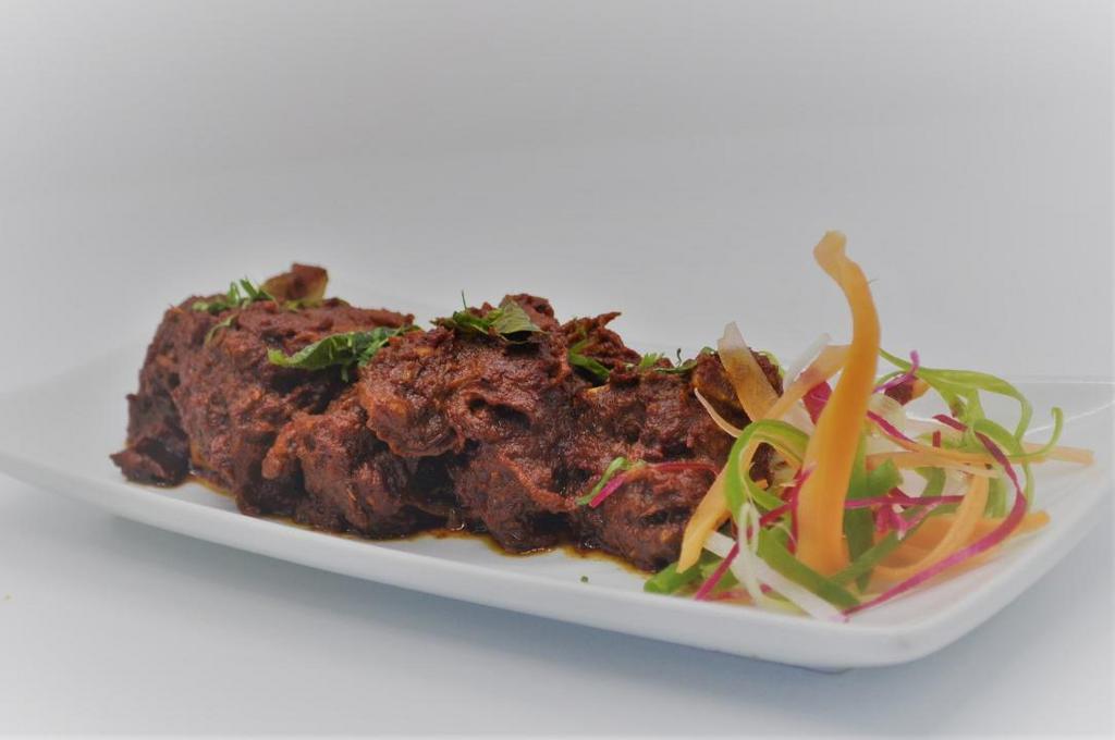 Goat Sukha · Tender goat meat cooked on slow flame with a touch of exotic spices