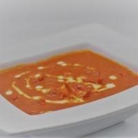 Butter Chicken · Boneless pieces of chicken cooked in rich tomato sauce and sweetened by honey and topped wit...