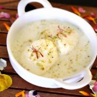Rasmalai · CHEESECAKE DUMPLING in Malai Sauce served with a garnish of pistachio and almonds