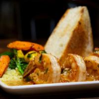 Camarones Al Ajillo · mexican sweet shrimp,
chile de árbol garlic butter, cilantro lime rice, ciabatta.