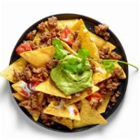 Birria Nachos · Goat meat along with guacamole, pico de gallo, sour cream, beans and cheese smothered ontop ...
