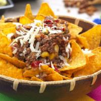 Tripa Nachos · Meat along with guacamole, pico de gallo, sour cream, beans and cheese smothered ontop of cr...