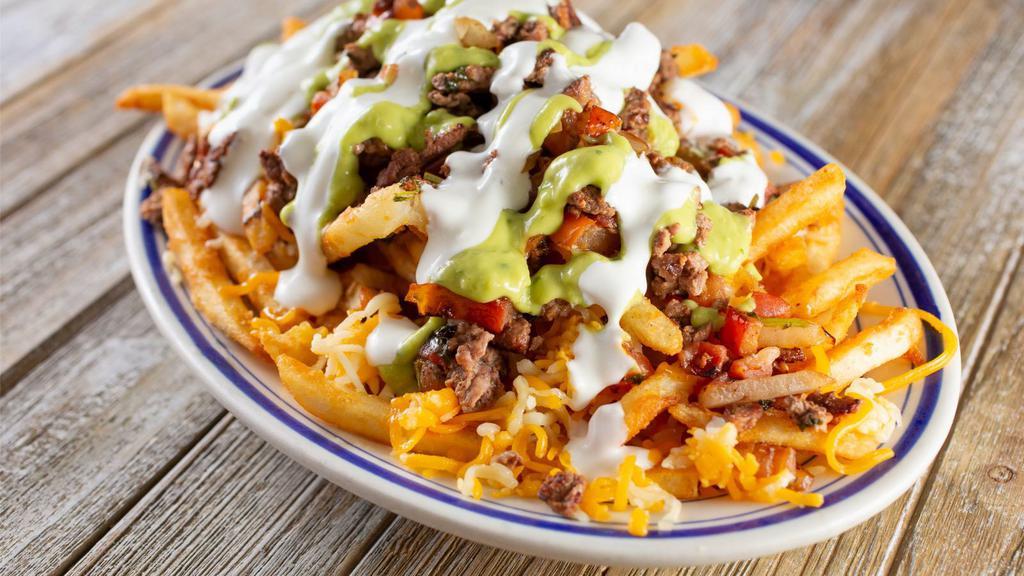 Asada Nacho Fries · Steak along with guacamole, pico de gallo, sour cream, beans and cheese smothered ontop of crispy fries.