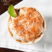 Elotitos · Sweet corn smoked with hickory and mesquite topped whipped lime crema, cotija cheese, and ta...