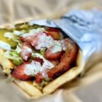 Chicken Shawarma Wrap · In pita bread with garlic, lettuce, tomatoes, onions, pickles and Tzatziki sauce.