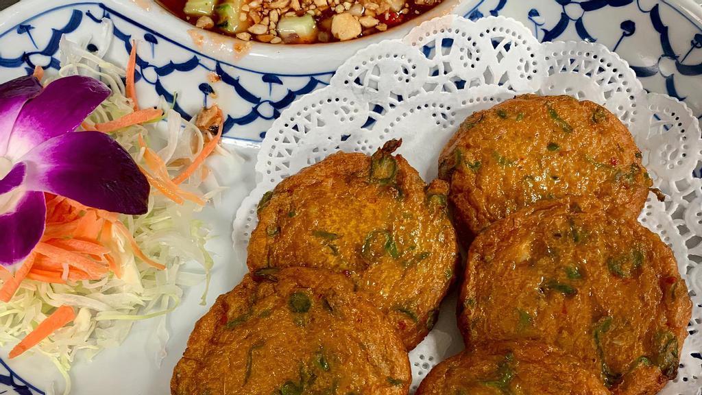 Fish Cake (5 Pieces) · Fish cake patties seasoned with curry paste and green bean, deep-fried and served with cucumber relish on the side.