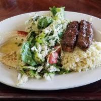Kefta Kebab Plate · Two pieces of grilled ground beef kebab served with rice, hummus, Mezzaterranean salad, and ...