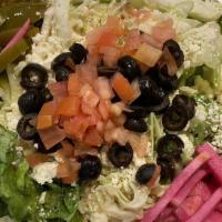 Greek Salad · Romaine lettuce, cabbage, tomatoes, cucumbers, olives, and feta cheese tossed with our homem...