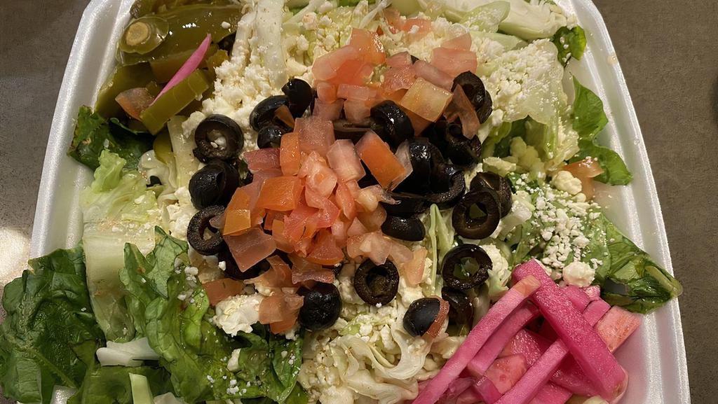 Greek Salad · Romaine lettuce, cabbage, tomatoes, cucumbers, olives, and feta cheese tossed with our homemade dressing. - VEGETARIAN