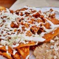 Chilaquiles Rojos Plate  · Chilaquiles, cheese, onion, cilantro, Eggs, Rice and beans.