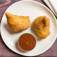 Vegetable Samosa · Vegan. Two samosas filled with spiced potato, cabbage, green onion, peas wrapped in a thin l...