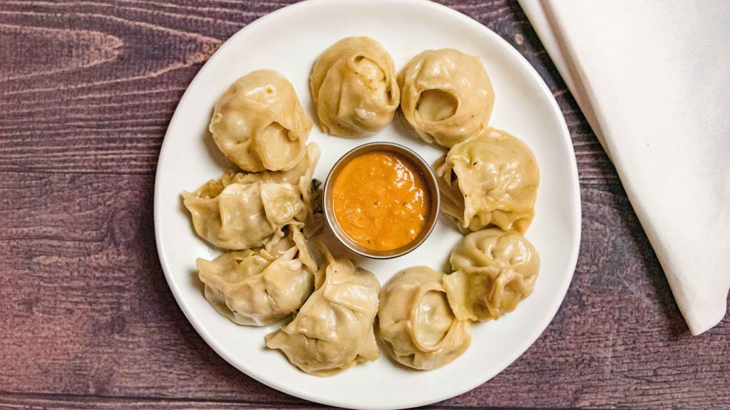 Vegetable Momo · Staple dish of Nepal. Flour pastry filled with spiced vegetables pinched into bite size parcels, steamed and served with fresh Himalayan sauce.