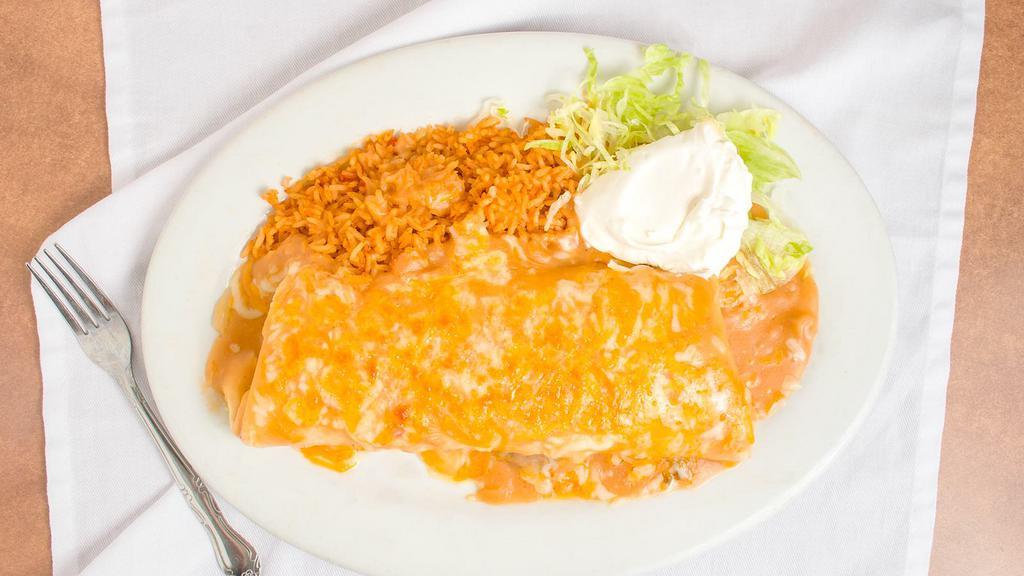 Carne Asada Burrito · Large flour tortilla filled with refried beans and slices of carne asada, smothered with homemade ranchera sauce, topped with cheese, and sour cream on the side.