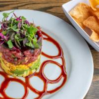 Ahi Tuna Stack · Chopped ahi tuna with ginger mango salsa, avocado, chili & poke sauce served with wonton chips