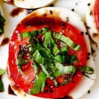 Caprese Salad · Sliced tomatoes with fresh Mozzarella and fresh basil.