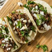 Carnitas Taco · Tacos with roast pork, served with onion, cilantro, radish, and lime, with a choice of green...