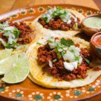 Chorizo Taco · Three pieces of tacos, served with onion, cilantro, radish, and lime, with a choice of green...