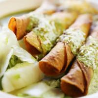  Rolled Taquitos · Crispy rolled chicken or beef taquitos served with 51 by 50 vegetarian beans, tomatillo sauc...