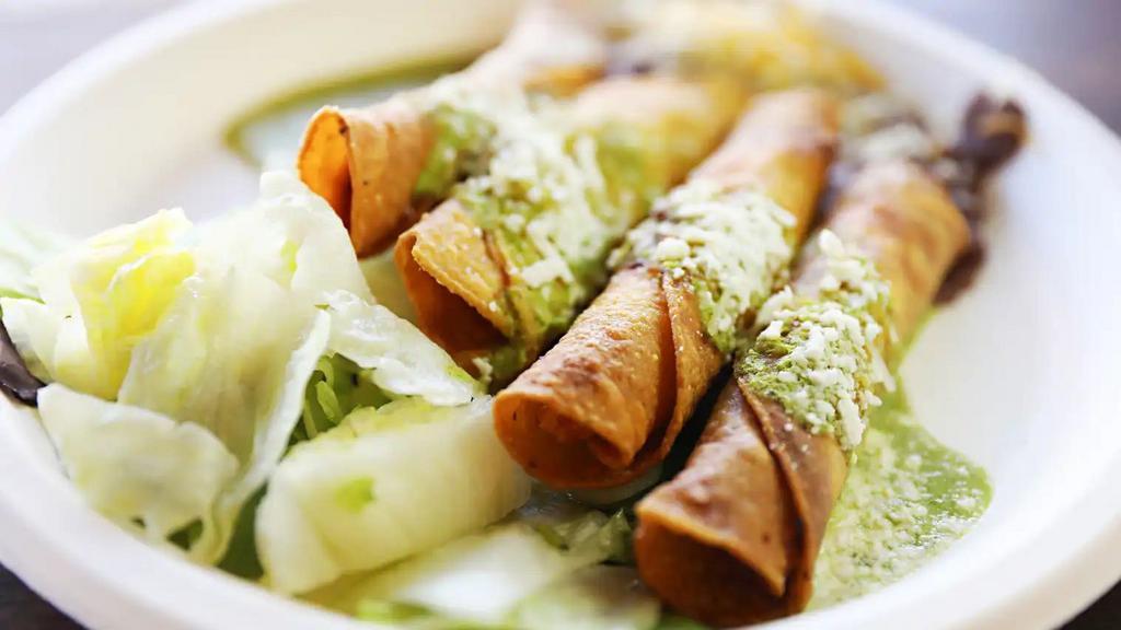  Rolled Taquitos · Crispy rolled chicken or beef taquitos served with 51 by 50 vegetarian beans, tomatillo sauce, and topped with cotija cheese.