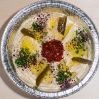 Hummus · Ground chickpeas with sesame sauce, blended with lemon juice, garlic and extra virgin olive ...
