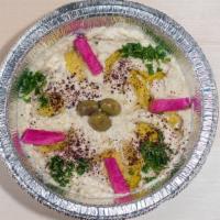 Baba Ghanoush · Baked, smoked eggplant marinated with lemon juice, garlic, extra virgin olive oil. Served wi...