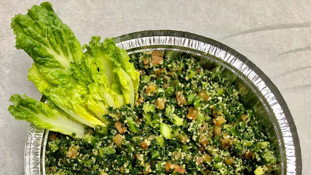 Tabouli Salad · A tantalizing salad made of cracked wheat, tomatoes, onions. Bell peppers, radishes and parsley tossed in a lemon juice and olive oil dressing. Served with romaine lettuce.