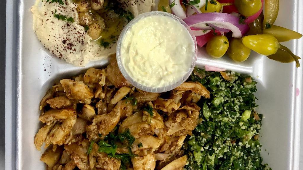 Chicken Shawarma · Marinated layers of chicken grilled to perfection on our vertical broiler. Served with hummus, salad and garlic sauce.