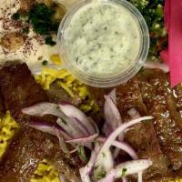 Gyro · Combination of lamb and beef ground together and served with basmati rice, hummus, salad and...