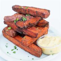 Sweet Potato Wedges · Sweet Potato Wedges, tossed in salt, pepper, and parsley. Served with a side of aioli.