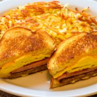 The General · Bacon, sausage, ham, egg and cheese sandwich on grilled sourdough served with potatoes.