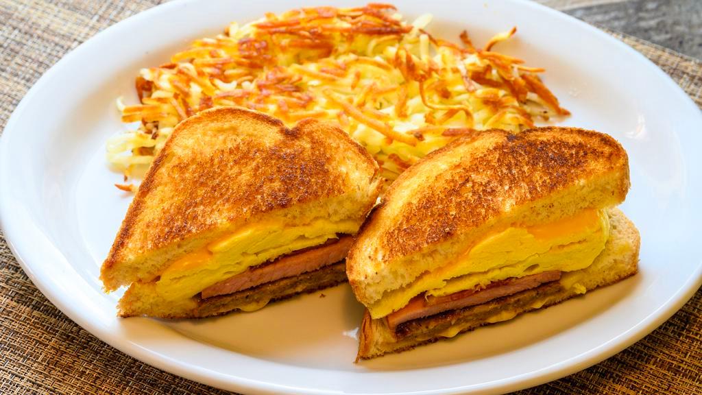 The General · Bacon, sausage, ham, egg and cheese sandwich on grilled sourdough served with potatoes.
