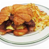 Croissant Sandwich · Bacon, egg, cheese, tomato, served with potatoes.