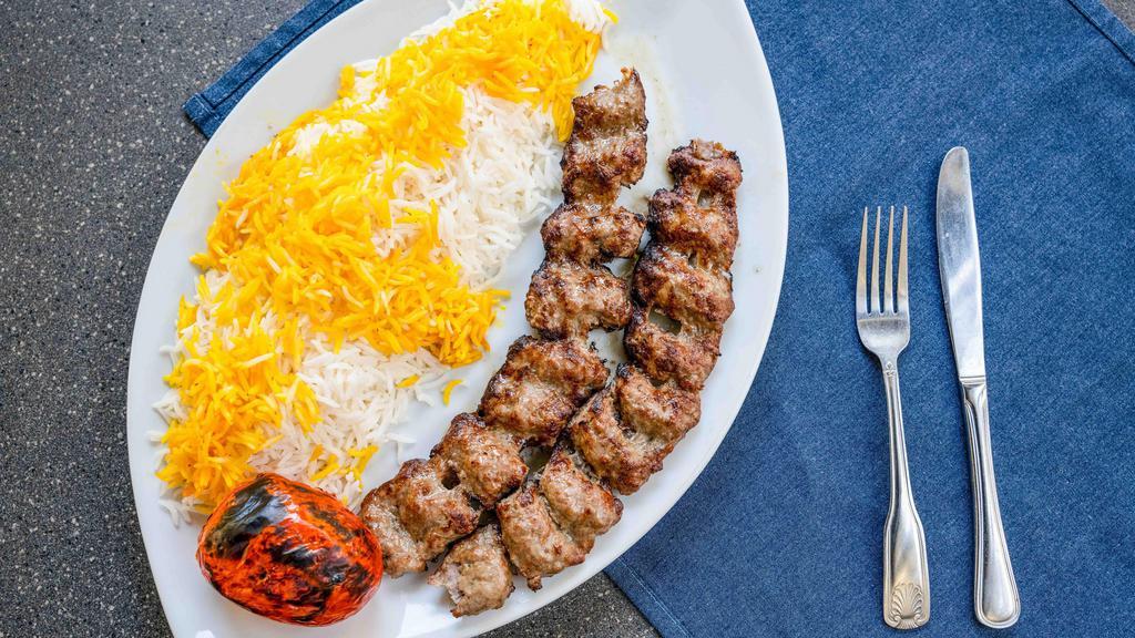 Beef Koobideh · Two skewers of freshly ground beef seasoned with onion and spices and broiled over an open flame.