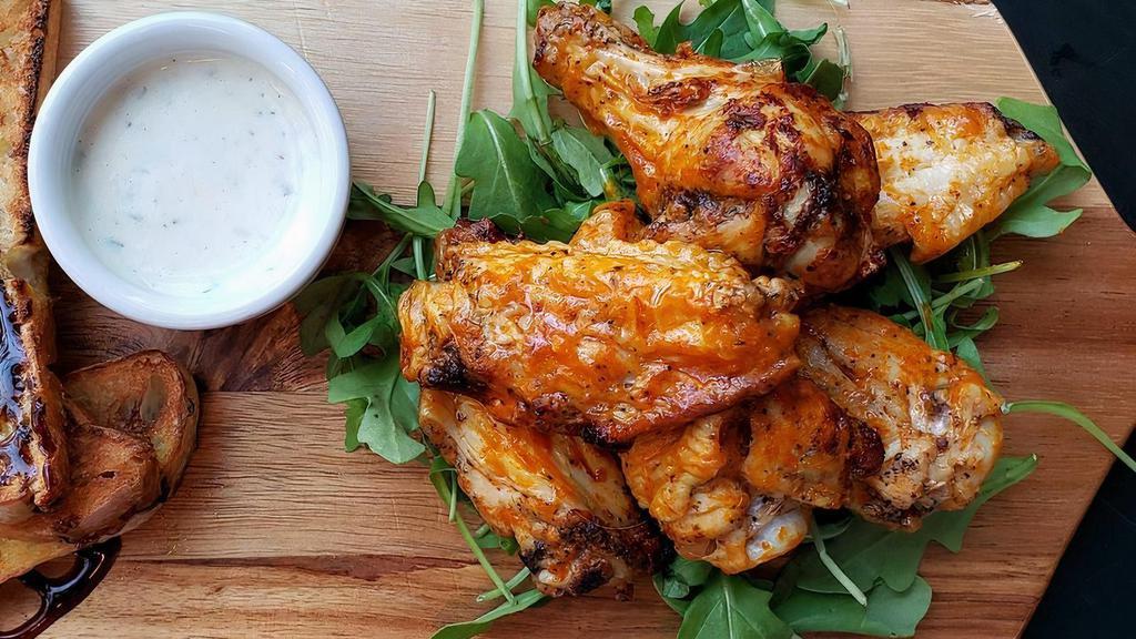 Wood-Fired Buffalo Wings · 6 spicy wings smothered in our housemade buffalo sauce. Served on a bed of arugula with a side of celery, carrots, & cooling housemade ranch.