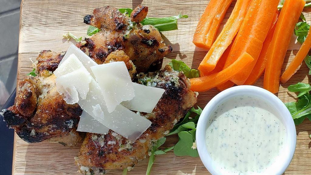 Wood-Fired Garlic Parmesan Wings · 6 wood fired wings dressed with garlic & parmesan. Served on a bed of arugula with a side of celery, carrots, & housemade ranch.