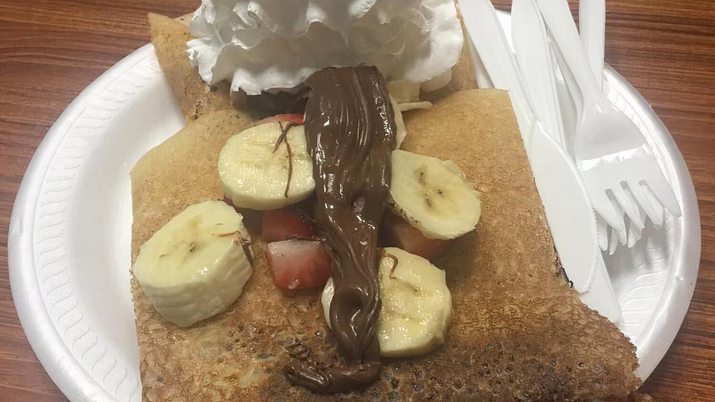 Banana Berry Chip Crêpe · Freshly made crêpe, topped with sliced banana, strawberries, and chocolate chips. Now comes with a scoop of homemade vanilla included.