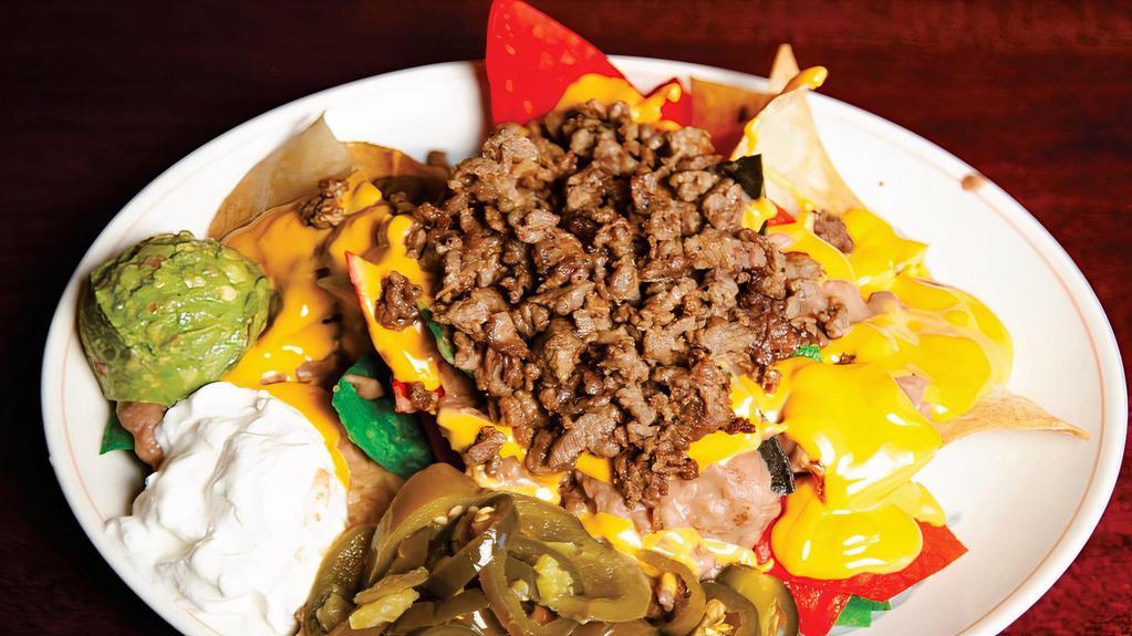 Nacho Supreme · Nacho cheese or jack cheese, beans, sour cream, guacamole and any meat.