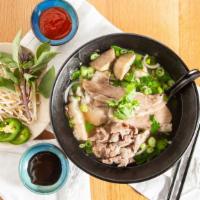 Pho Combination · Served with Rib-Eye, Brisket, Tendon and Meatballs. 
Rib Bone is extra $2.5