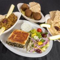Baba Ghanoush Appetizer · A baked dip containing eggplant, fresh lemon juice, sesame tahini and garlic, served with pi...